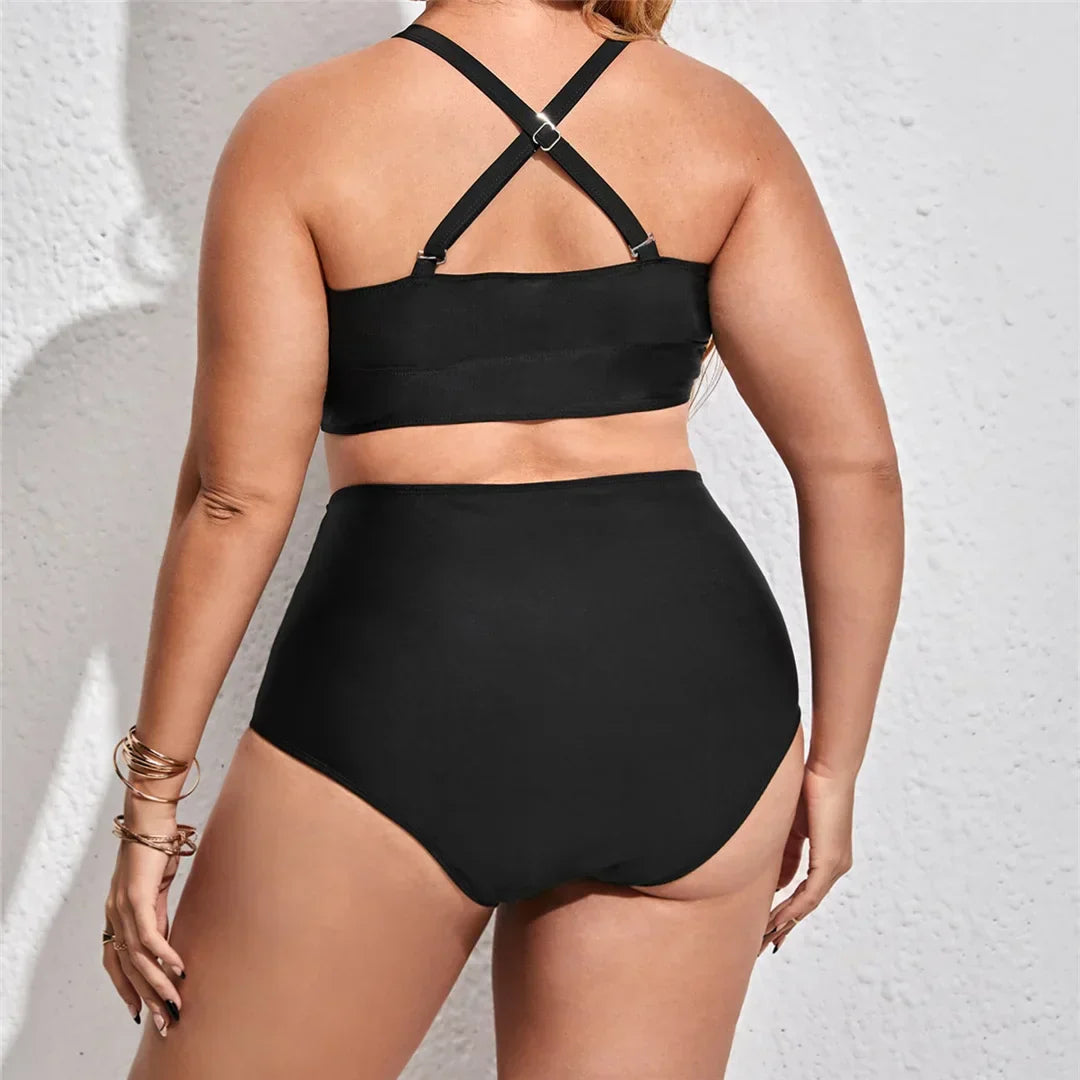 Plus size two-piece swimsuit with decorative straps across the chest.
