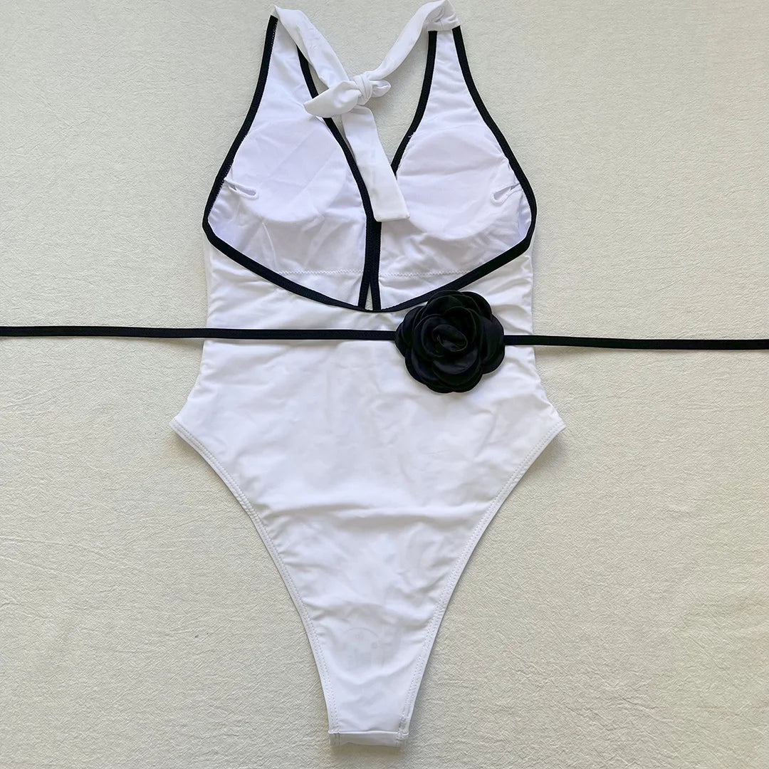 One-piece swimsuit with decorative rose