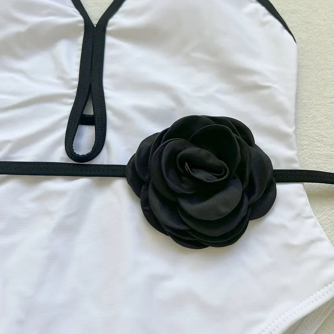 One-piece swimsuit with decorative rose