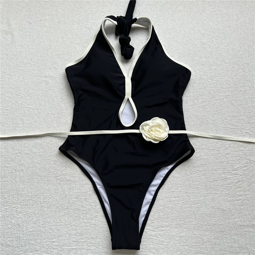 One-piece swimsuit with decorative rose